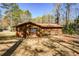 Exterior view of a wood sided home with a red roof and large yard at 4800 Timber Ridge Dr, Douglasville, GA 30135