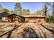 Rear exterior of the house shows a deck and outdoor living space in the yard at 4800 Timber Ridge Dr, Douglasville, GA 30135