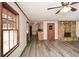 Open living room featuring a stone fireplace, wood-look floors, and view to the kitchen at 4800 Timber Ridge Dr, Douglasville, GA 30135