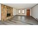 Living room showcasing stone fireplace and newly installed modern flooring at 4800 Timber Ridge Dr, Douglasville, GA 30135