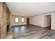 View of living room with stone fireplace and wood-look flooring at 4800 Timber Ridge Dr, Douglasville, GA 30135