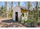 Dilapidated white storage shed surrounded by vegetation at 4800 Timber Ridge Dr, Douglasville, GA 30135