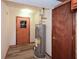 Utility room featuring a water heater, door, and wood-look floors at 4800 Timber Ridge Dr, Douglasville, GA 30135