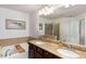 Bathroom features a soaking tub, shower with glass door and granite countertop double sink vanity at 6038 Mayfield Se Way, Mableton, GA 30126