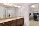Spacious bathroom vanity with dual sinks, ample counter space, and a doorway view to an office at 6038 Mayfield Se Way, Mableton, GA 30126