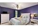 Bedroom boasts purple walls, white furniture, and decorative poster and bedside lamp at 6038 Mayfield Se Way, Mableton, GA 30126