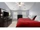 Comfortable bedroom with soft blue walls, a large dresser, and a plush red quilt at 6038 Mayfield Se Way, Mableton, GA 30126
