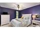 Cozy bedroom with a ceiling fan, plush carpeting, and calming purple walls that create a relaxing atmosphere at 6038 Mayfield Se Way, Mableton, GA 30126
