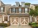 Charming townhome with stone accents, dormer windows, and a convenient two-car garage at 6038 Mayfield Se Way, Mableton, GA 30126