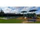 Community playground featuring a covered picnic area and fun play structures, set against a backdrop of green space at 6038 Mayfield Se Way, Mableton, GA 30126