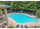 An aerial view of a community pool with many lounge chairs and blue umbrellas for shade at 6038 Mayfield Se Way, Mableton, GA 30126