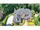 Aerial view of a brick home with mature landscaping, well-manicured lawn, and stone walkway at 10020 Normandy Ln, Suwanee, GA 30024