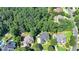 An aerial view showcases a well-maintained property nestled among mature trees and neighboring homes at 10020 Normandy Ln, Suwanee, GA 30024