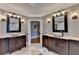 Dual vanities with vessel sinks and decorative mirrors in a spacious, well-lit bathroom at 10020 Normandy Ln, Suwanee, GA 30024