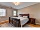 Bedroom features a bed, rug, windows, and decorative side tables at 10020 Normandy Ln, Suwanee, GA 30024