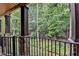 A lovely view of the backyard through the wrought iron fence on the covered back deck at 10020 Normandy Ln, Suwanee, GA 30024