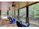 Enjoy this covered deck with stone floor and ceiling fans overlooking a scenic backyard at 10020 Normandy Ln, Suwanee, GA 30024