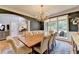 Charming dining room with hardwood floors, chandelier, and bright natural light from large windows at 10020 Normandy Ln, Suwanee, GA 30024