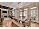 Open dining room with stone fireplace and access to outdoor living space at 10020 Normandy Ln, Suwanee, GA 30024