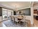 Elegant dining room with chandelier lighting, ample windows, and access to the kitchen at 10020 Normandy Ln, Suwanee, GA 30024