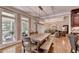 Dining room with natural light flowing through large windows and wooden table at 10020 Normandy Ln, Suwanee, GA 30024