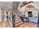 Staircase with a decorative chandelier, high ceilings, and hardwood floors at 10020 Normandy Ln, Suwanee, GA 30024