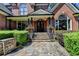 Inviting stone walkway leads to the front door, framed by elegant landscaping and brickwork at 10020 Normandy Ln, Suwanee, GA 30024