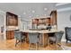 Kitchen island with seating, custom cabinetry and stone countertops at 10020 Normandy Ln, Suwanee, GA 30024