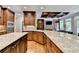 Spacious kitchen boasts custom cabinets, granite counters, and modern stainless appliances at 10020 Normandy Ln, Suwanee, GA 30024