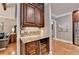 Kitchen with wine cooler, stone countertops and hardwood floors at 10020 Normandy Ln, Suwanee, GA 30024