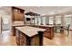 Open kitchen, showcasing the large island, dining area, and access to the outdoor space at 10020 Normandy Ln, Suwanee, GA 30024