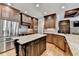 Gourmet kitchen with stainless steel appliances, custom cabinetry, and hardwood floors at 10020 Normandy Ln, Suwanee, GA 30024