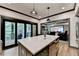 Kitchenette features an island with bar seating that opens to an outdoor entertainment space at 10020 Normandy Ln, Suwanee, GA 30024