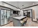 Modern kitchenette features stainless steel appliances, a central island, and bar seating at 10020 Normandy Ln, Suwanee, GA 30024