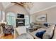 Cozy living room with high ceilings, fireplace, and plenty of natural light from large arched windows at 10020 Normandy Ln, Suwanee, GA 30024