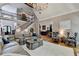 Bright living room with soaring ceilings, cozy seating, and eye-catching chandelier at 10020 Normandy Ln, Suwanee, GA 30024