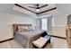 Serene main bedroom with tray ceilings, comfortable bedding, and a tranquil atmosphere at 10020 Normandy Ln, Suwanee, GA 30024