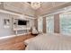 The spacious main bedroom features a decorative tray ceiling and many windows at 10020 Normandy Ln, Suwanee, GA 30024