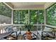 This screened porch has a view of the trees and landscaping at 10020 Normandy Ln, Suwanee, GA 30024