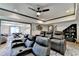 Home theater boasts leather reclining seats, ceiling fan and pool table in adjacent game room at 10020 Normandy Ln, Suwanee, GA 30024