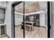 Elegant wine cellar featuring glass door entry, custom racks and a tasting table at 10020 Normandy Ln, Suwanee, GA 30024