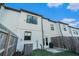 Exterior back of townhomes with fenced backyard and A/C unit at 160 Auburn Gate Ln, Auburn, GA 30011