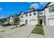 Picture showcases the townhome's facade, manicured lawn, and convenient two-car garage at 160 Auburn Gate Ln, Auburn, GA 30011