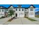 Charming exterior view showcasing the white painted brick and modern design of the townhome at 160 Auburn Gate Ln, Auburn, GA 30011
