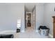 Hallway with light blue walls leads to staircase and features large mirror and laundry hamper at 160 Auburn Gate Ln, Auburn, GA 30011