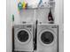 Laundry room with two modern LG washing machines and shelving storage at 160 Auburn Gate Ln, Auburn, GA 30011