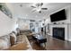 Open-concept living room with hardwood floors, fireplace, and lots of natural light at 160 Auburn Gate Ln, Auburn, GA 30011