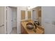 Bathroom with unique stone vessel sink, bamboo wall art, and modern fixtures at 3907 Cedar Cir, Tucker, GA 30084