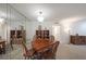 Comfortable dining room boasts wood table and chair set, display shelving, and updated light fixture at 3907 Cedar Cir, Tucker, GA 30084