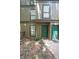 Inviting condo exterior with vibrant green doors and well-maintained landscaping at 3907 Cedar Cir, Tucker, GA 30084